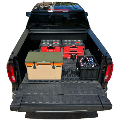 GMC short bed truck with Tmat securing boxes and a cooler